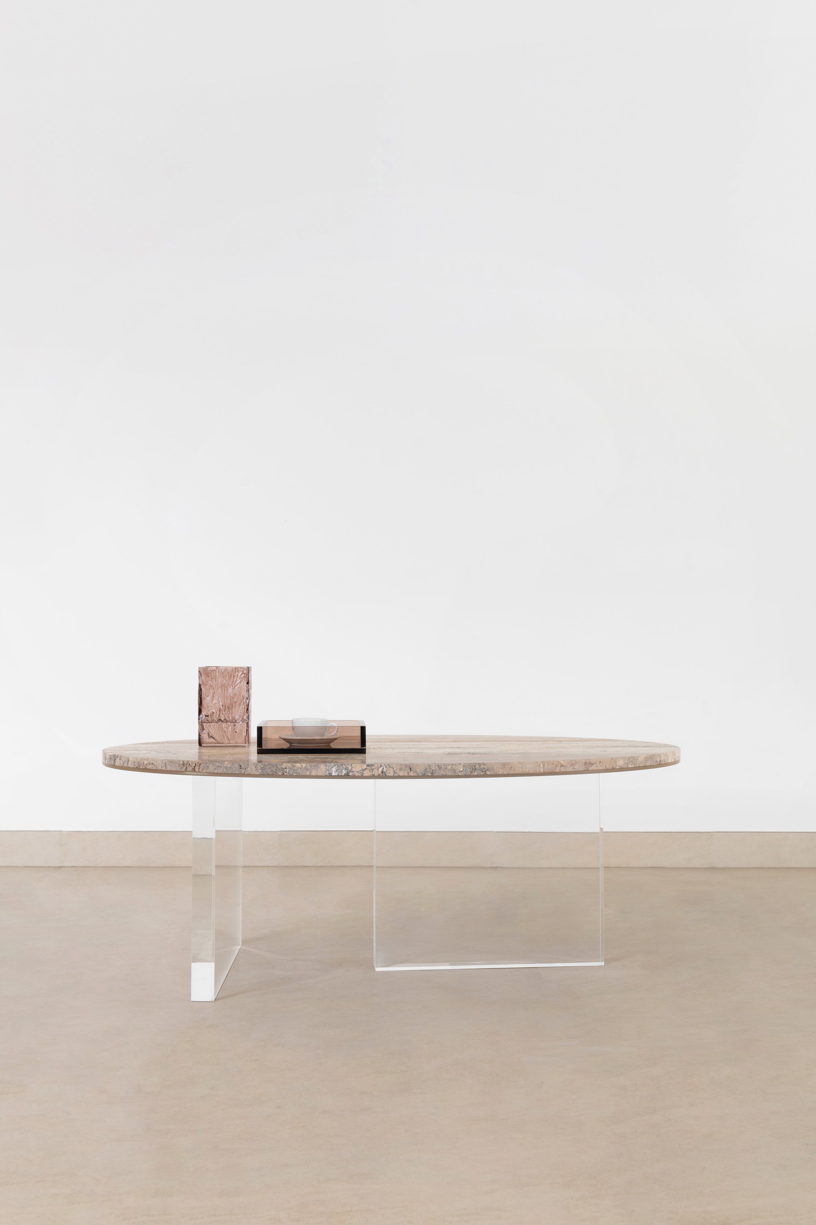 The OVAL travertine and acrylic coffee table